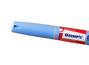Close-up of an Ozempic pen, a medication device for diabetes management, featuring a blue cap and a red label with dosage information.