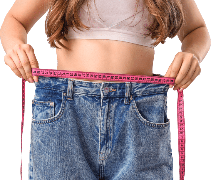 A woman measuring her waist with a tape measure, focusing on her midsection in a well-lit room.