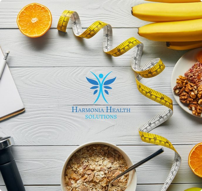 A bunch of bananas, oranges, and apples arranged with a measuring tape, suggesting a focus on healthy eating and portion sizes.