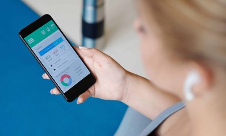 woman holding phone with weight loss app