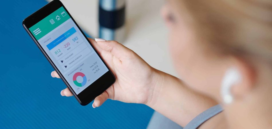 woman holding phone with weight loss app
