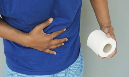 man with diarrhea holding tissue paper