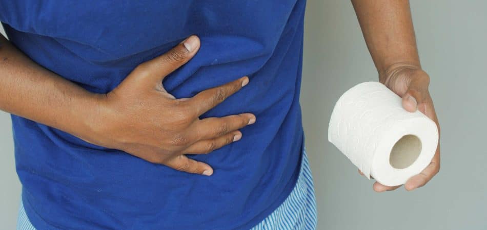 man with diarrhea holding tissue paper