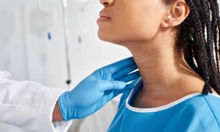 woman patient being checked by doctor for thyroid problem