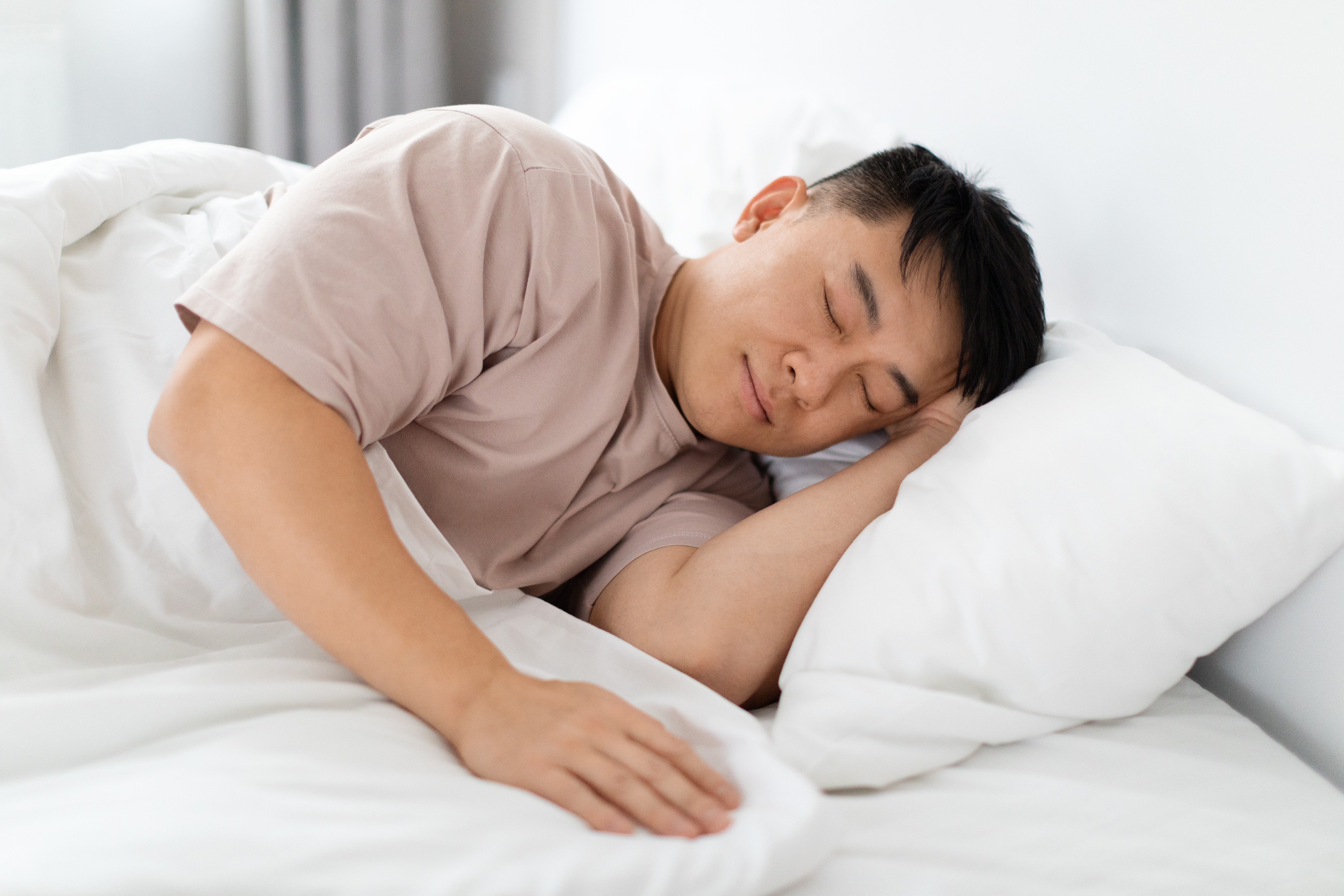 man sleeping alone in bed